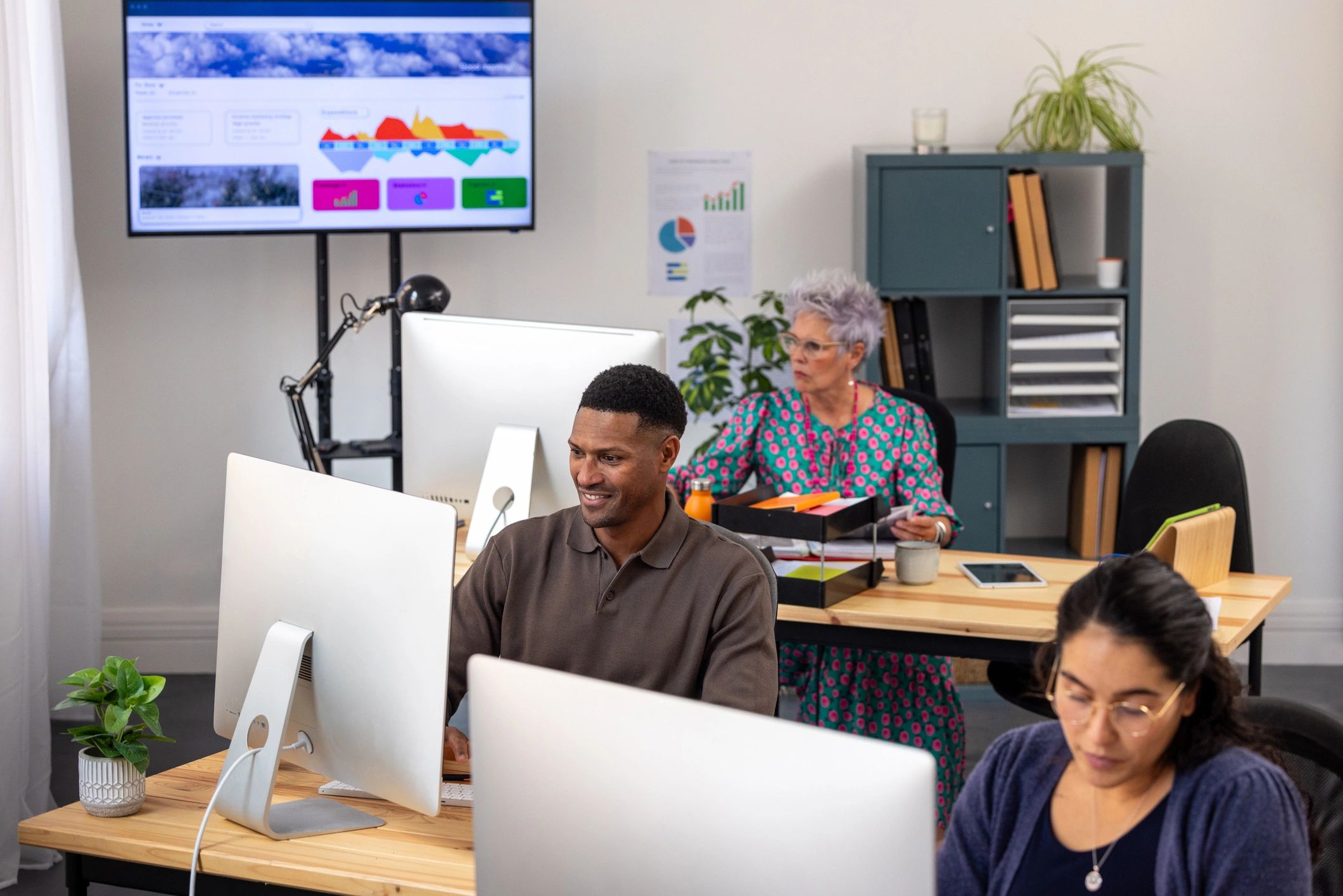 Business IT support team collaborating at an office desk