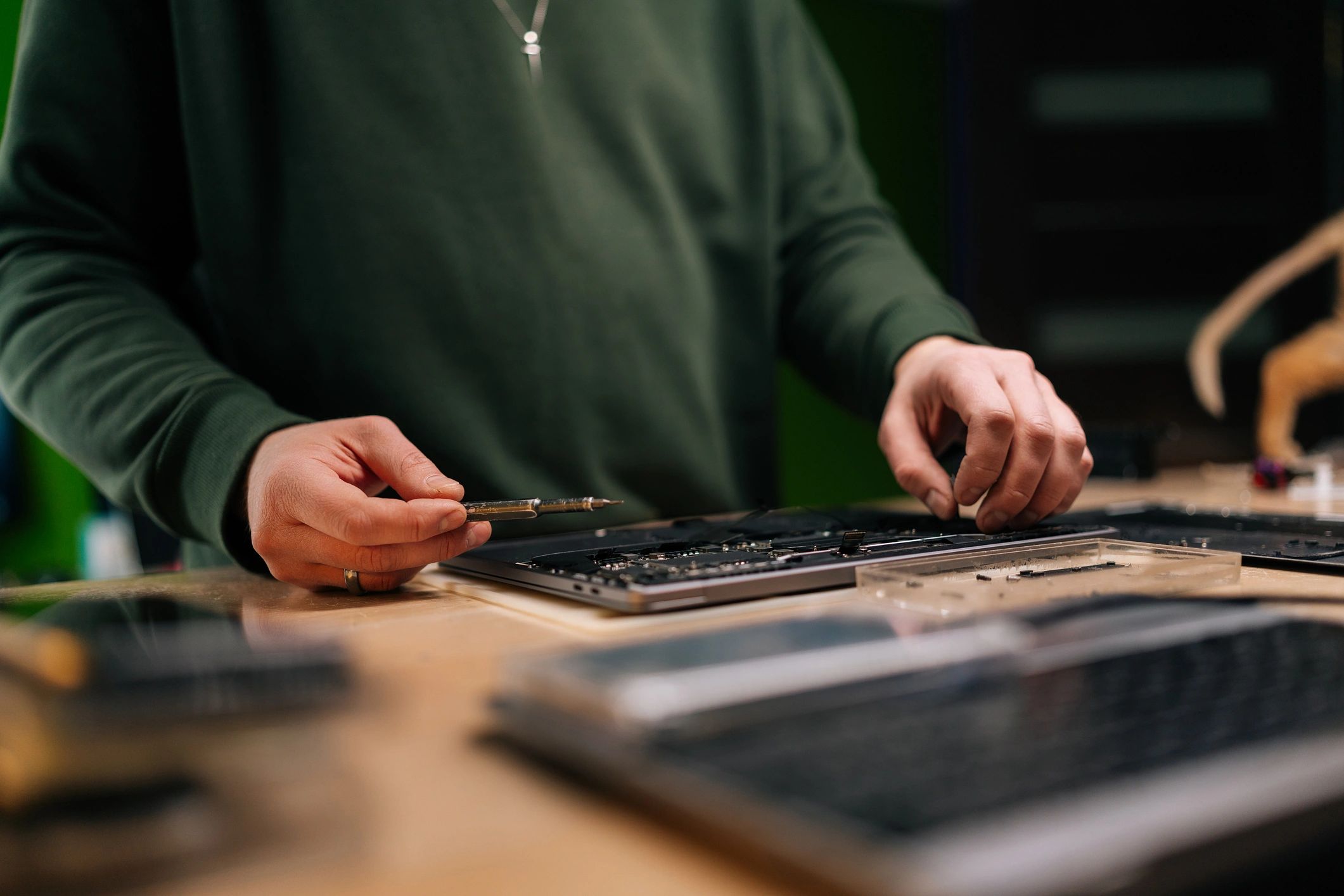 Technician performing laptop repair service