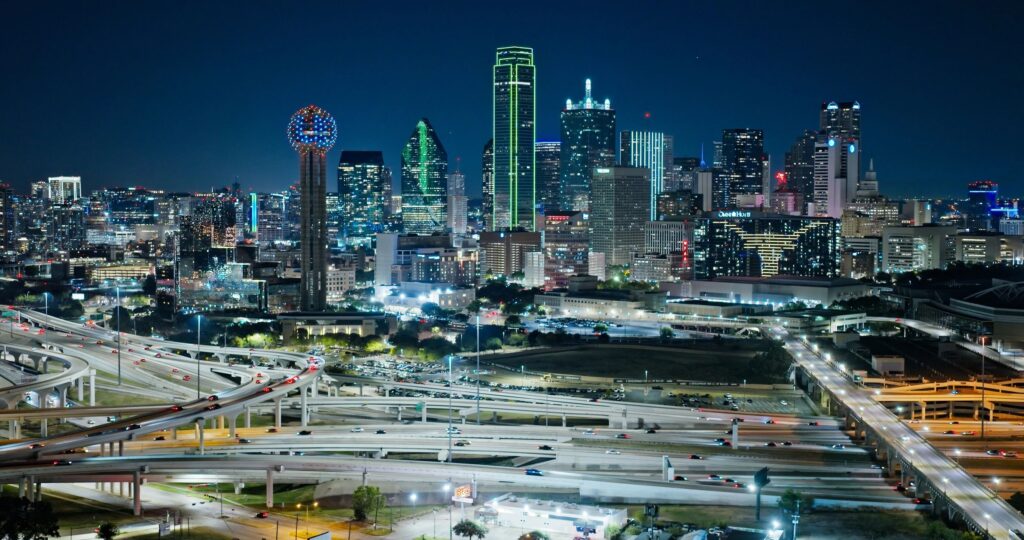 Aerial View of Downtown Dallas Skyline and Highway Interchange at Night, Texas