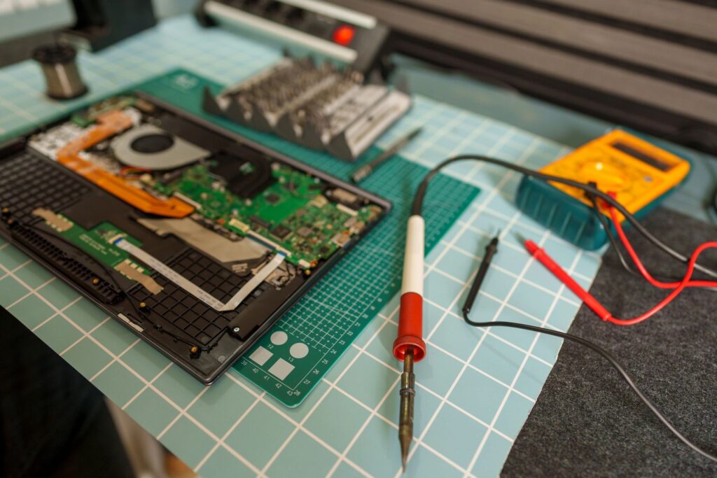 Repairing laptop computer motherboard with soldering iron