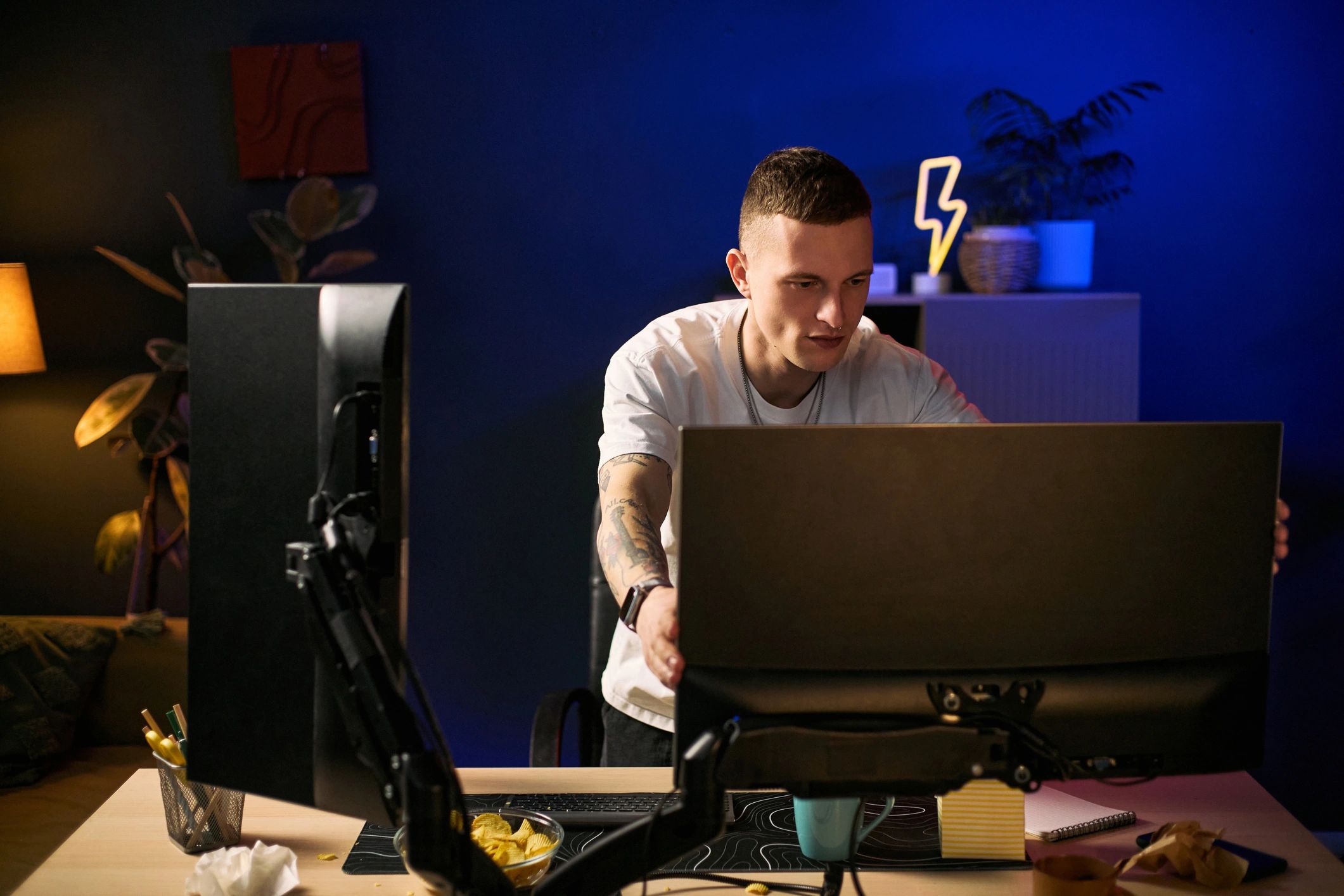 Technician adjusting a computer monitor at a desk