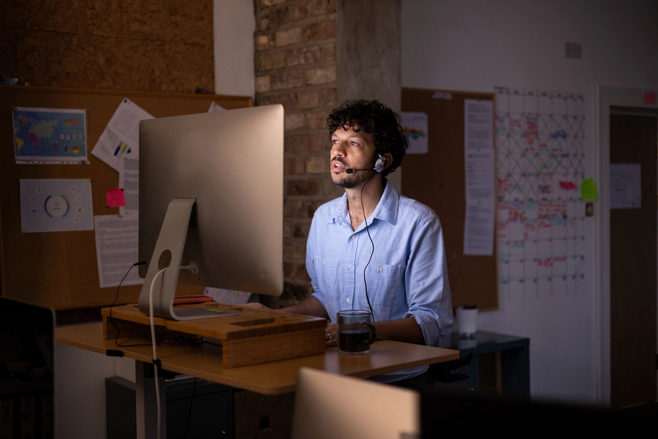 Remote IT support specialist assisting clients from a modern office